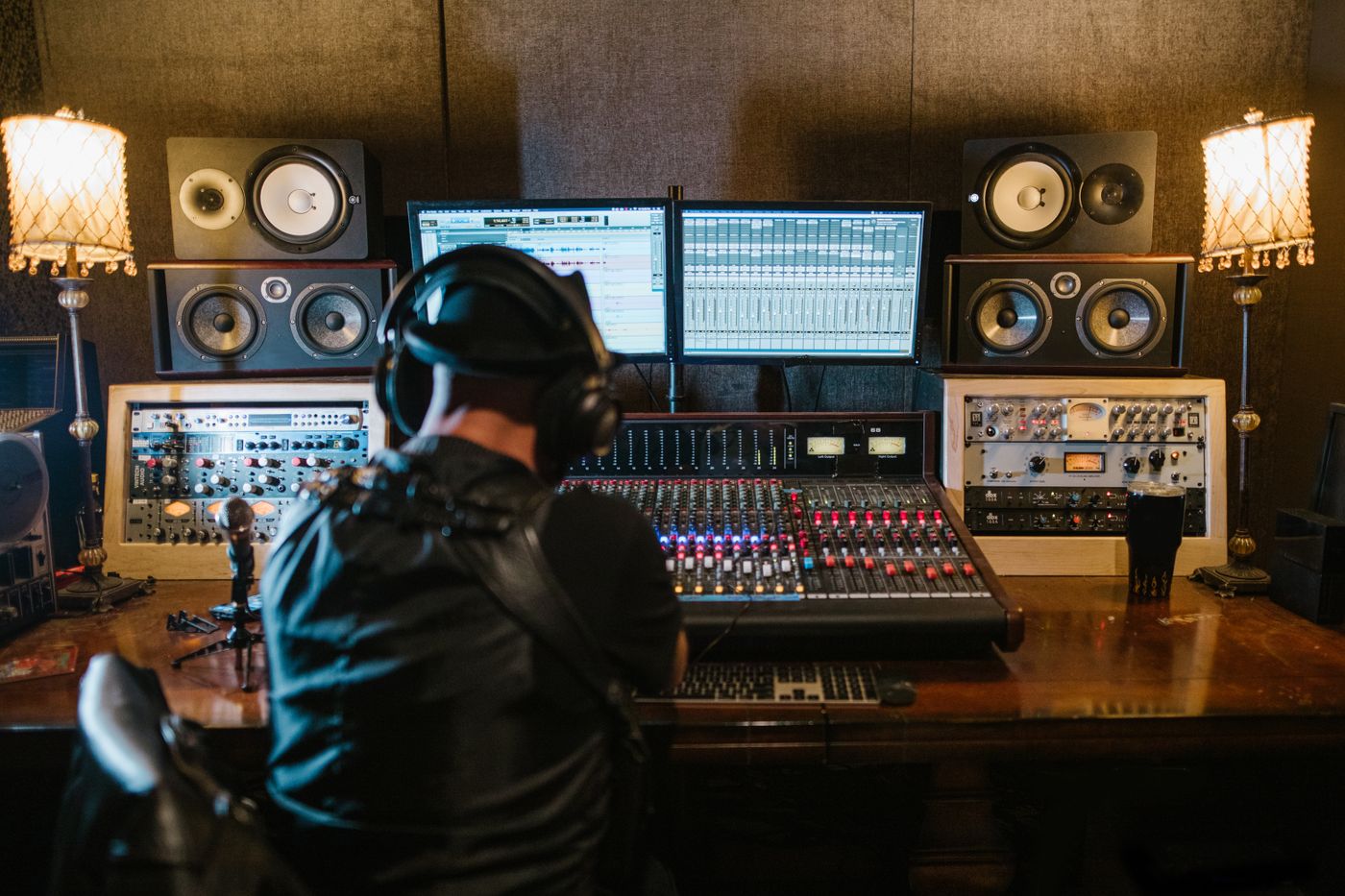 Music producer reviewing an audio session and digital release details on a studio computer