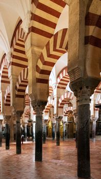 Stunning view of the iconic arches and columns inside the historic Mosque-Cathedral of Córdoba.
