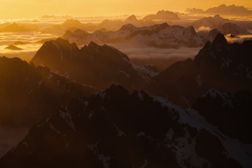 Aerial Photography of Snow-Covered Mountains during Sunset