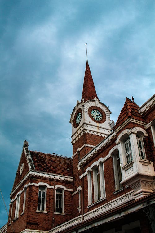 Low Angle Shot of Brick Building Under the Cloudy Sky 