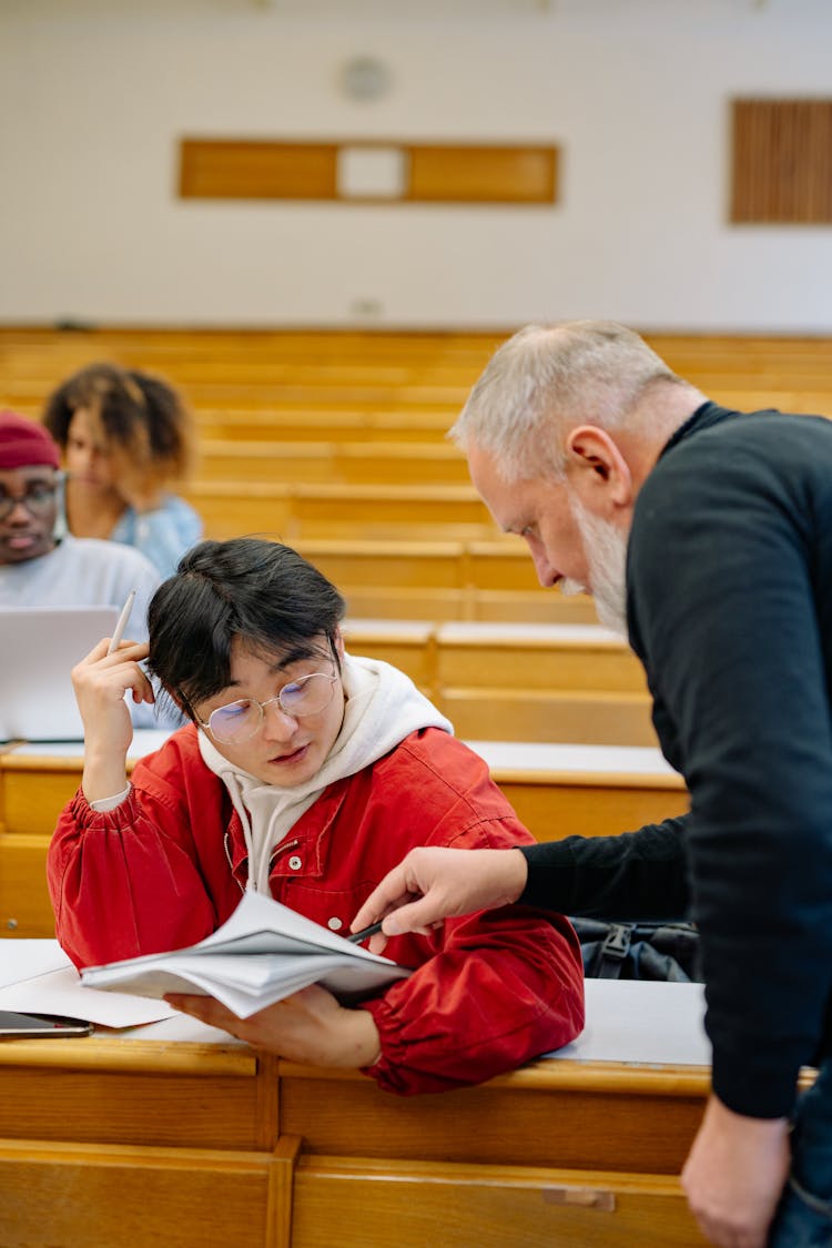 Professor Helping Student At University