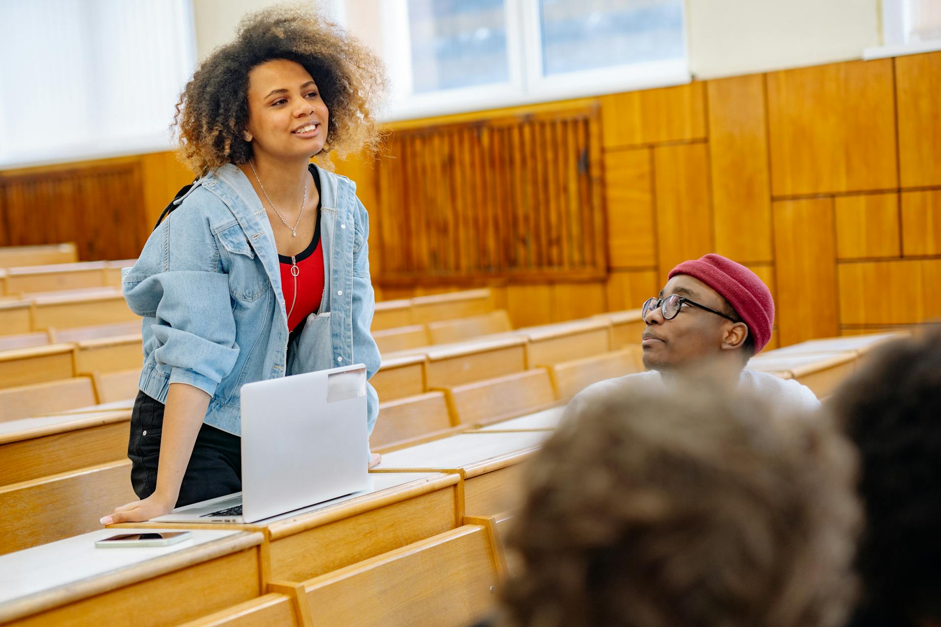 Students actively participating in a university lecture, engaging in discussion and study.