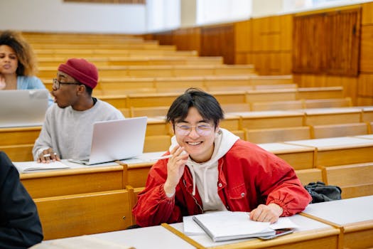 Smiling students studying together in a university lecture hall, promoting diversity and collaboration.