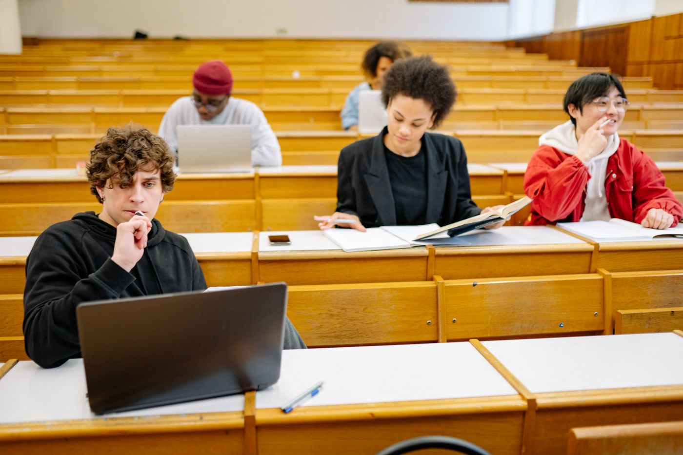 University students studying with laptops in a classroom
