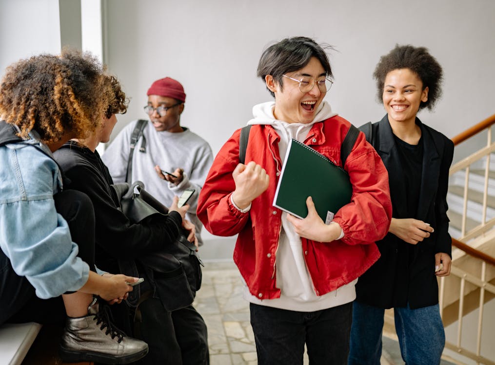Free Group of Students Talking at a Staircase Stock Photo