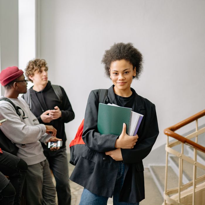 Student holding notebooks on campus, photo by Yan Krukau on Pexels