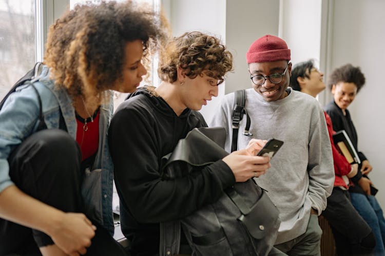 College Students Looking At A Cellphone