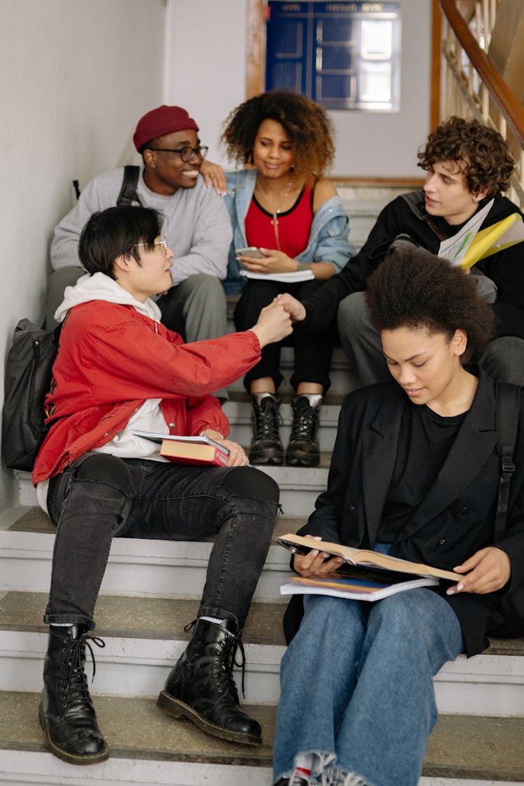 Group Of Students Sitting On Stairs