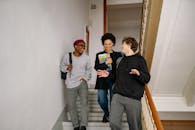 Friends Laughing while Going Down the Stairs