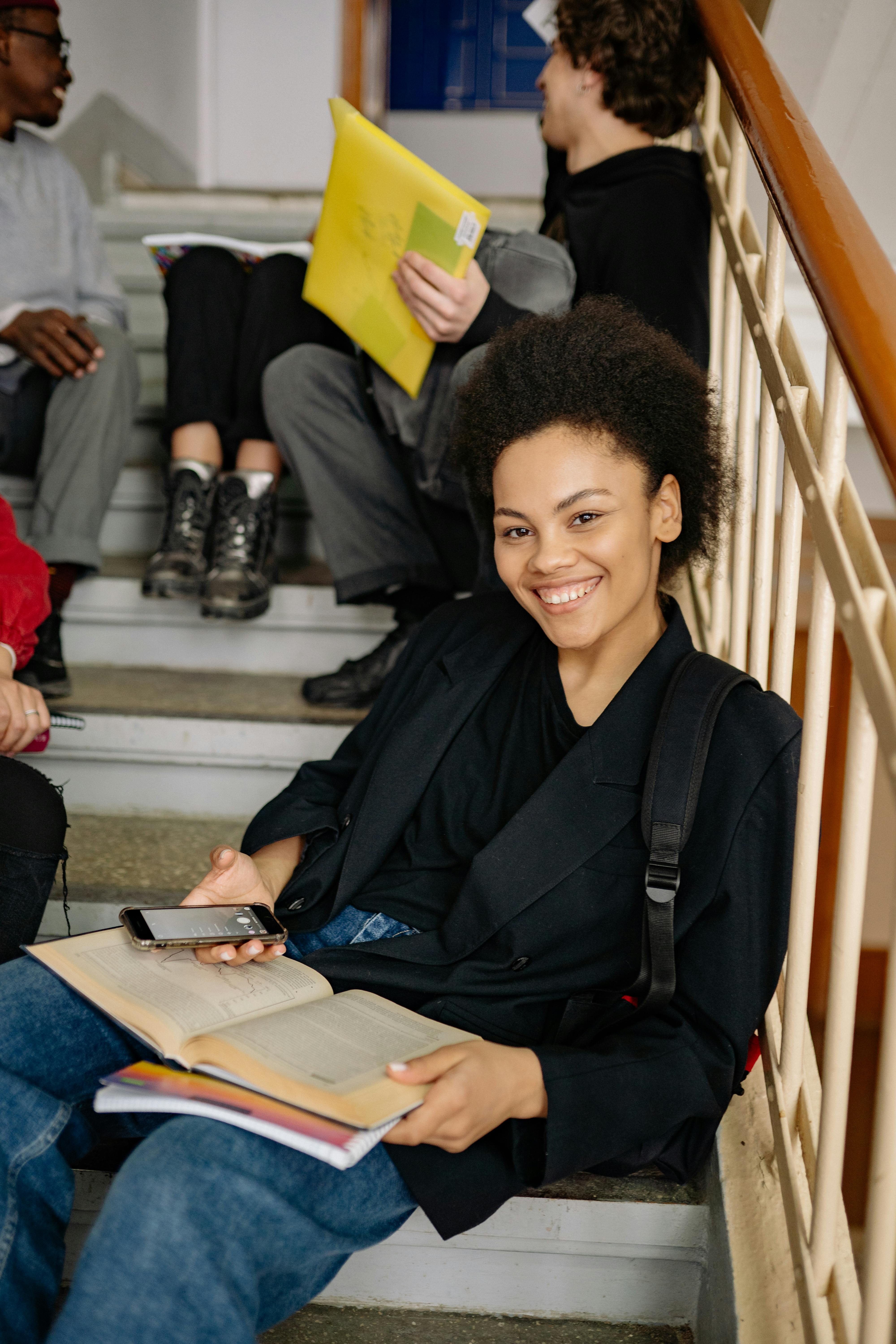 a woman sitting on the step of a staircase