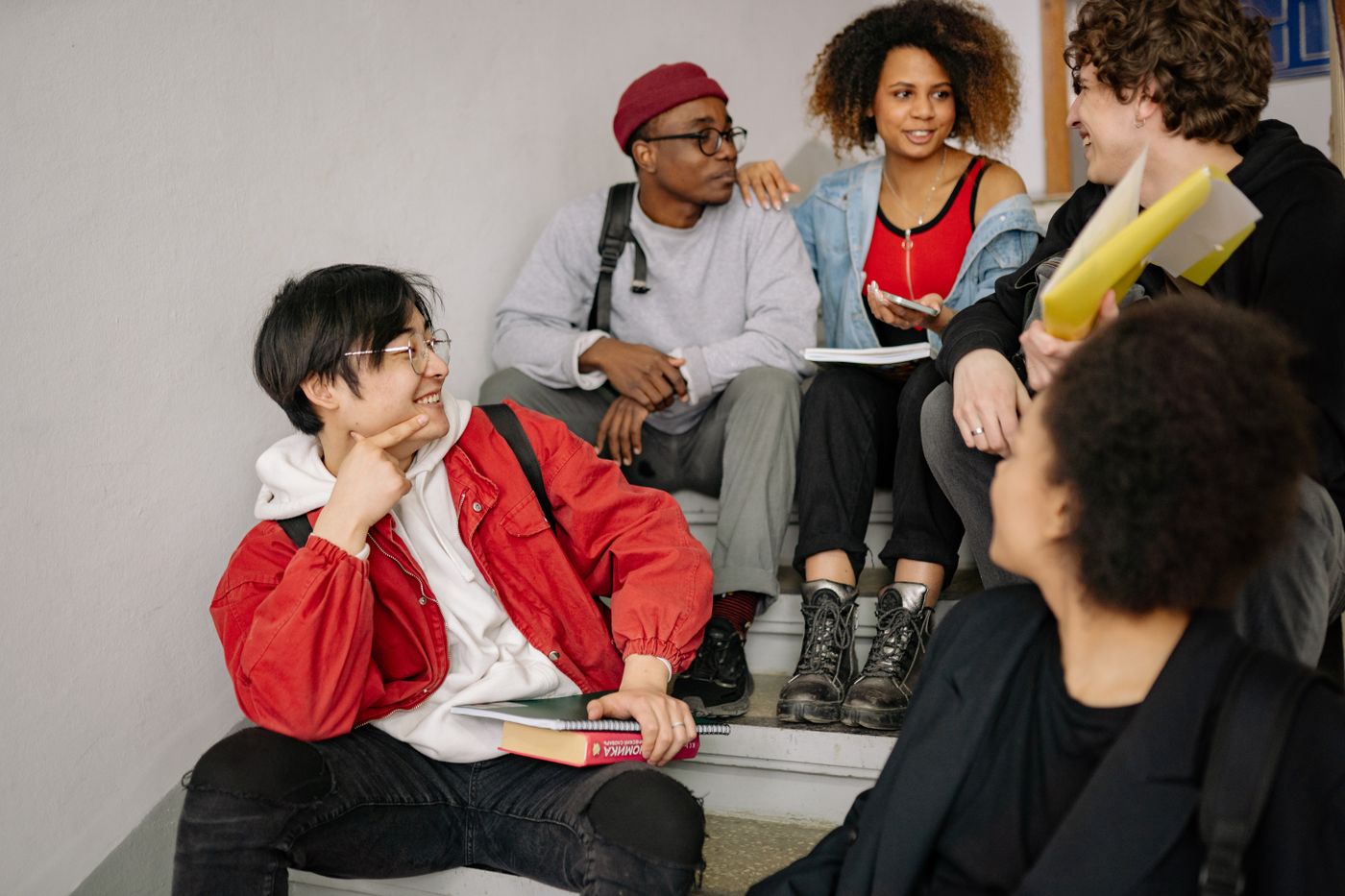Group of students sitting together on steps