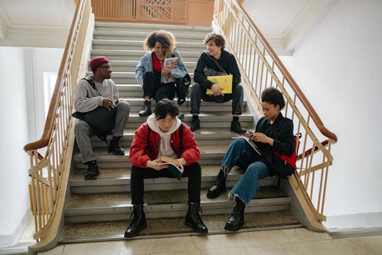 Group Of College Students  Sitting On The Stairs