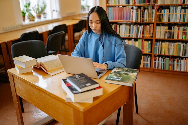 Student Using Laptop In Library