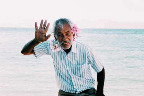 Man in Stripe Button Down Shirt Waving His Hand