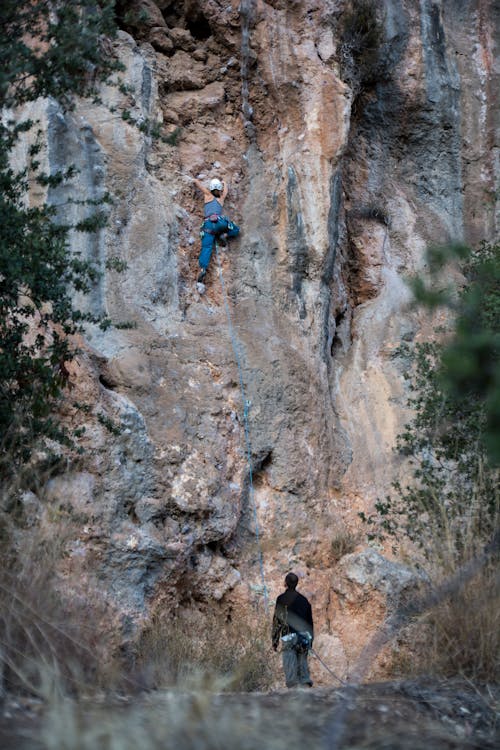 Climbers Climbing a Mountainside