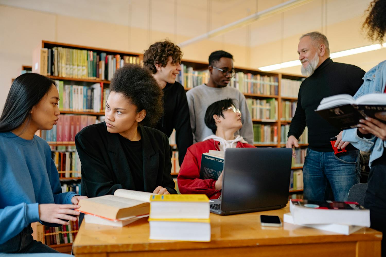 Diverse group of students studying together at university library