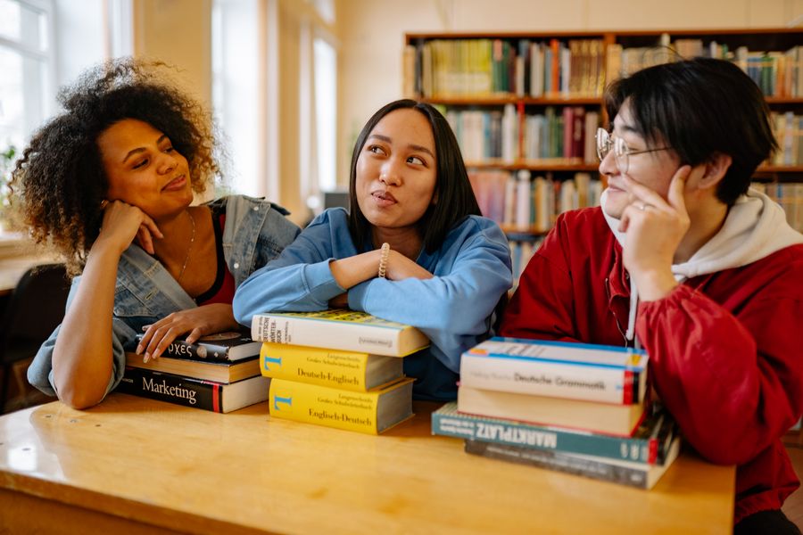 Students researching study options together in a university library