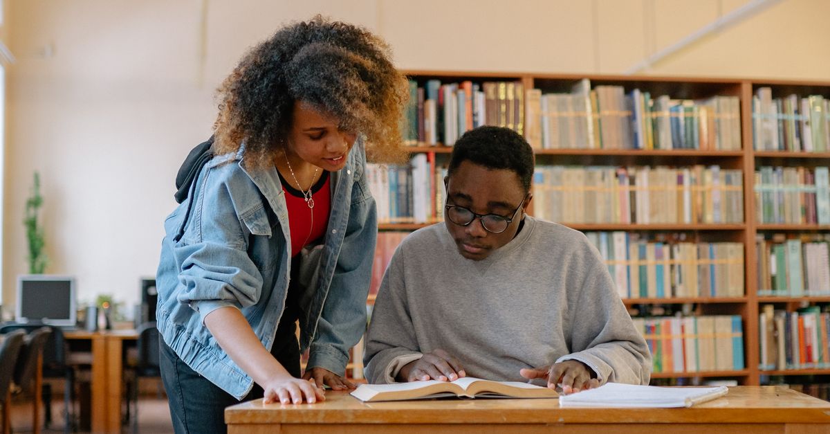 Humans In Library Man and Woman inside the Library · Free Stock Photo