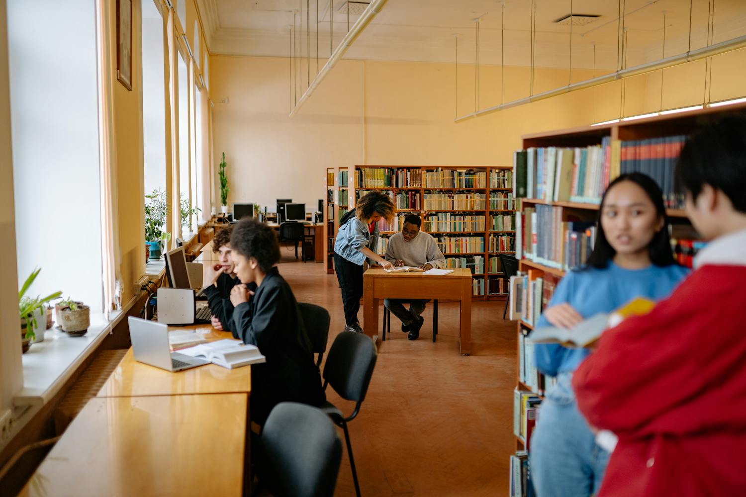 Students studying and collaborating in a university library setting