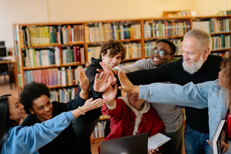 Group Of Students And Bearded Man Giving High Five