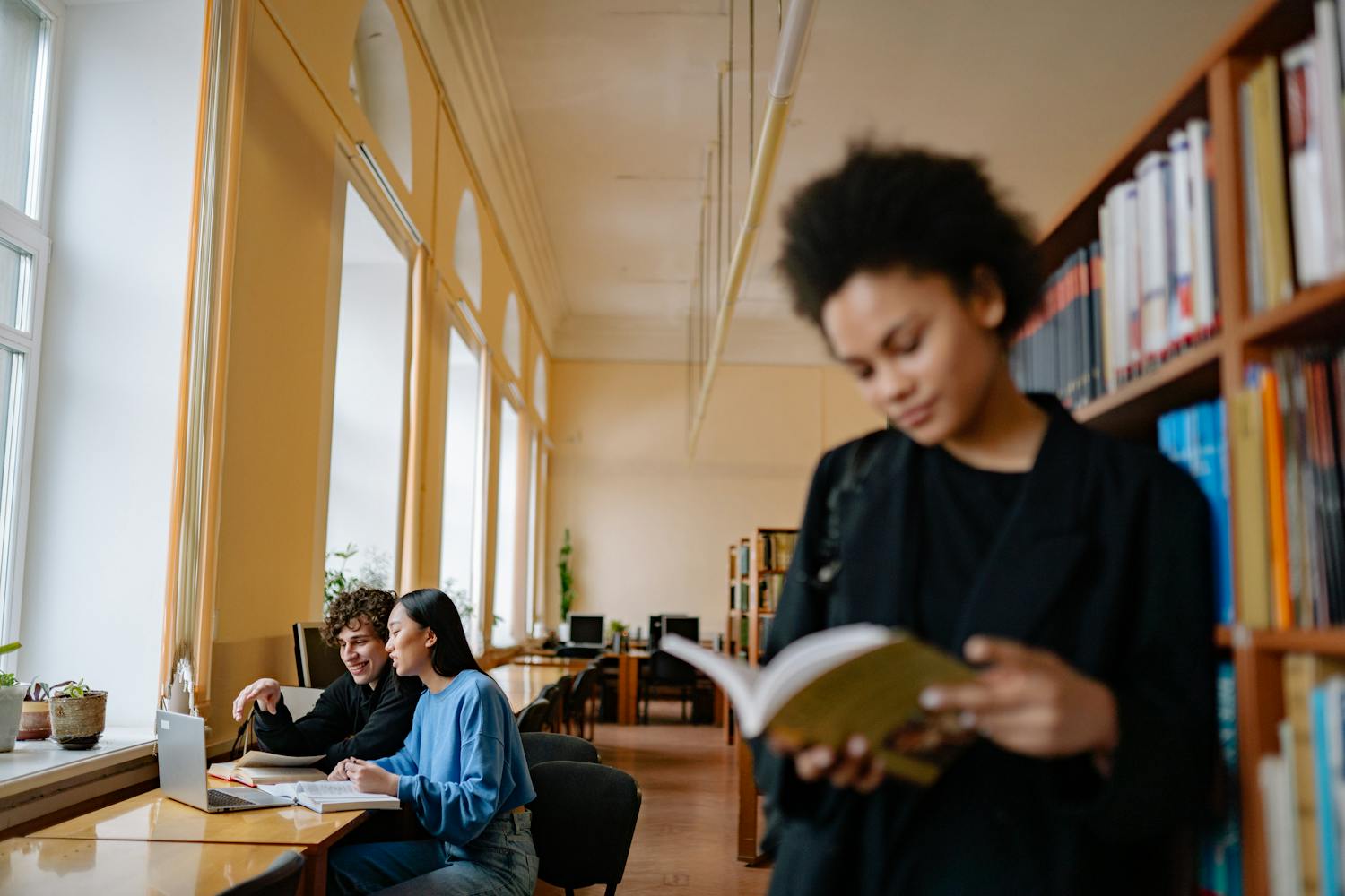Students engaged in study sessions inside a university library