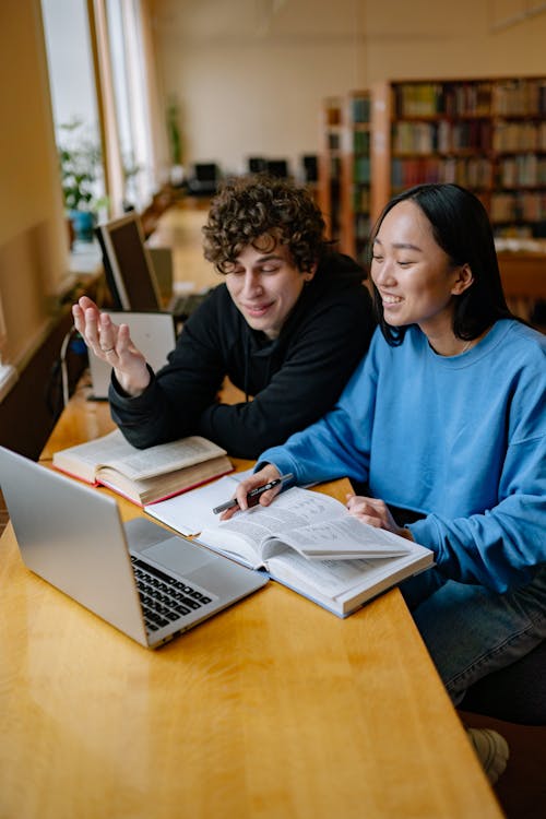 A Man and a Woman Sitting in a Library