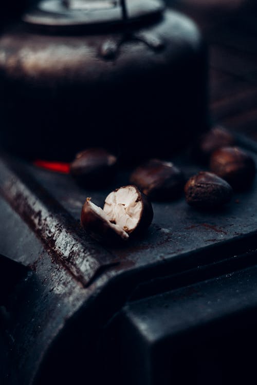 Free Closeup of tasty roasted chestnuts and portable kettle placed on portable stove for camping Stock Photo