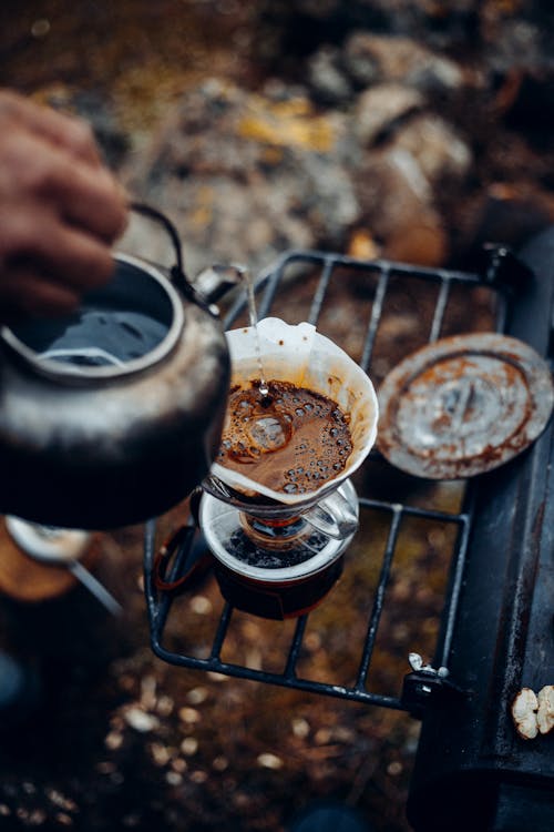 Free Hand making coffee while resting in mountains Stock Photo