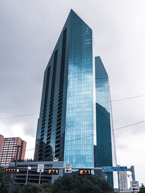 Free Dramatic vertical shot of a modern skyscraper on McKinney Avenue in a bustling city skyline. Stock Photo