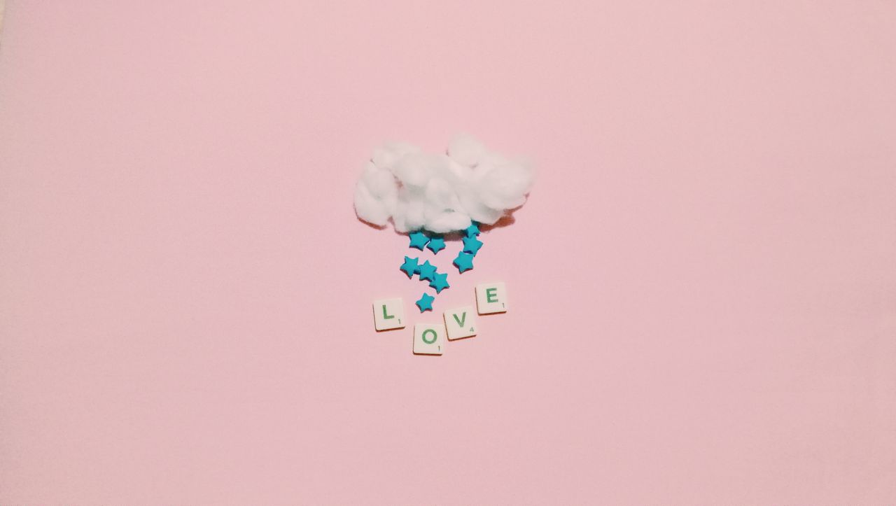 minimalistic arrangement with cotton cloud stars and love letters on p