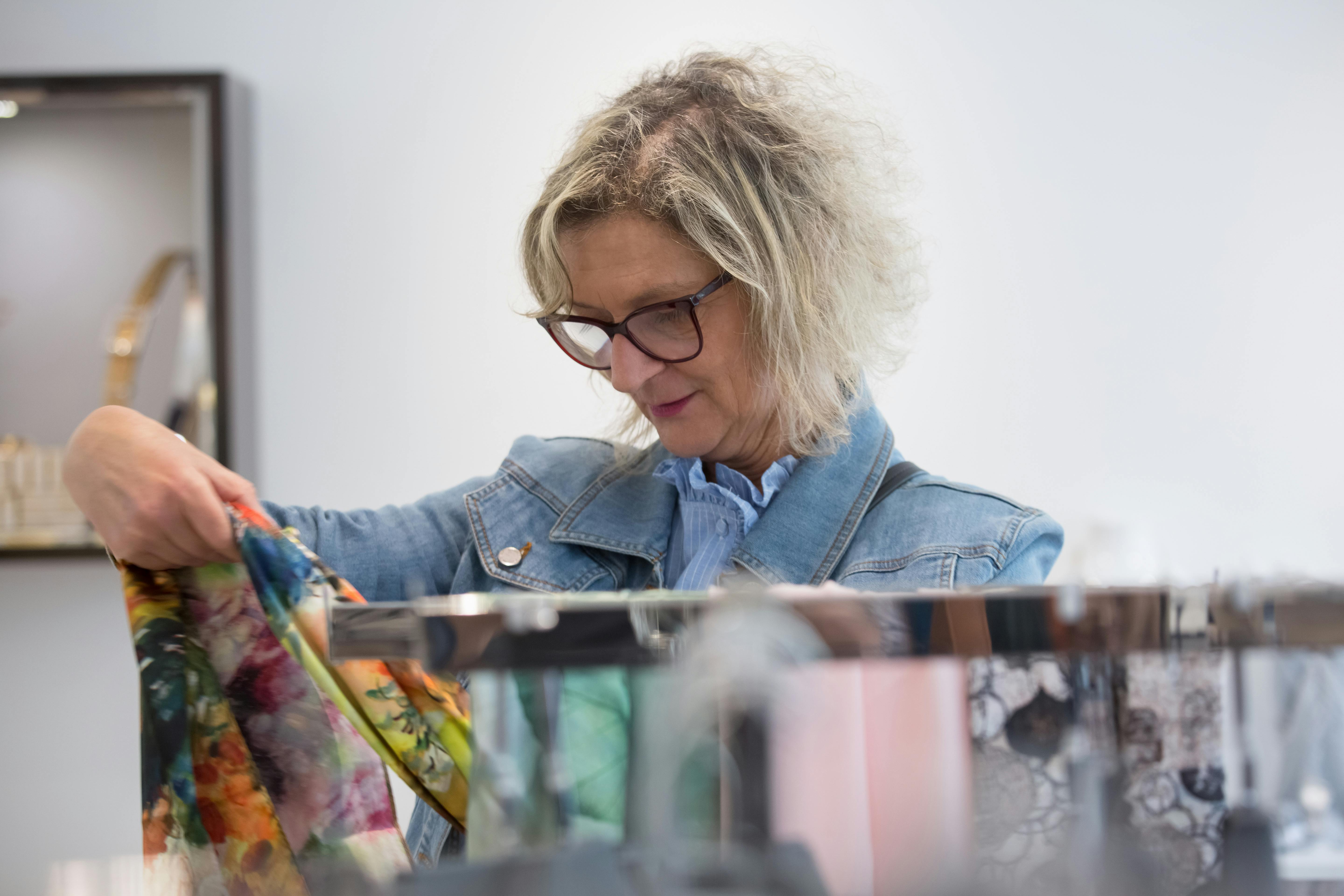 Elderly Woman in Denim Jacket Holding a Scarf · Free Stock Photo