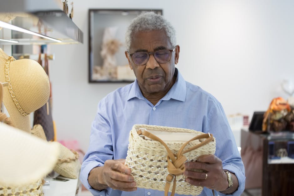 Senior man browsing straw bags in a stylish indoor shop setting.