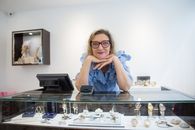 Woman in Blue Shirt Standing Behind the Counter