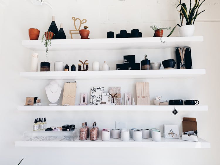 Shelves Full Of Trinkets, Candles And Pots