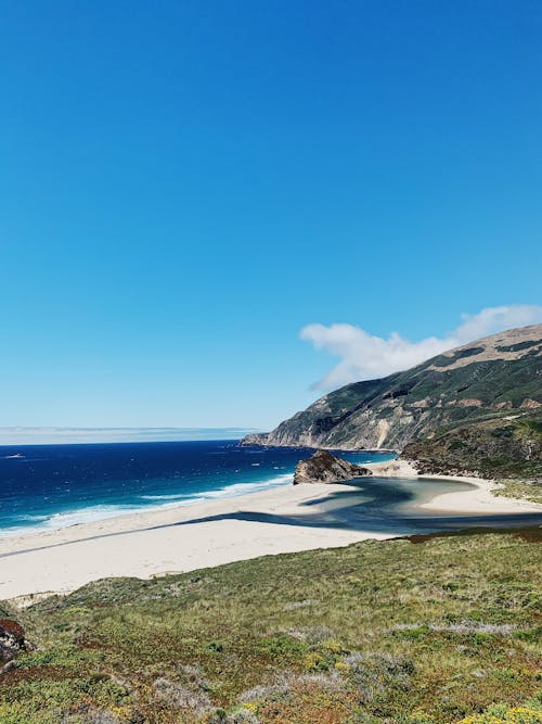 Sea with Sandy Beach and Rocky Coastline 