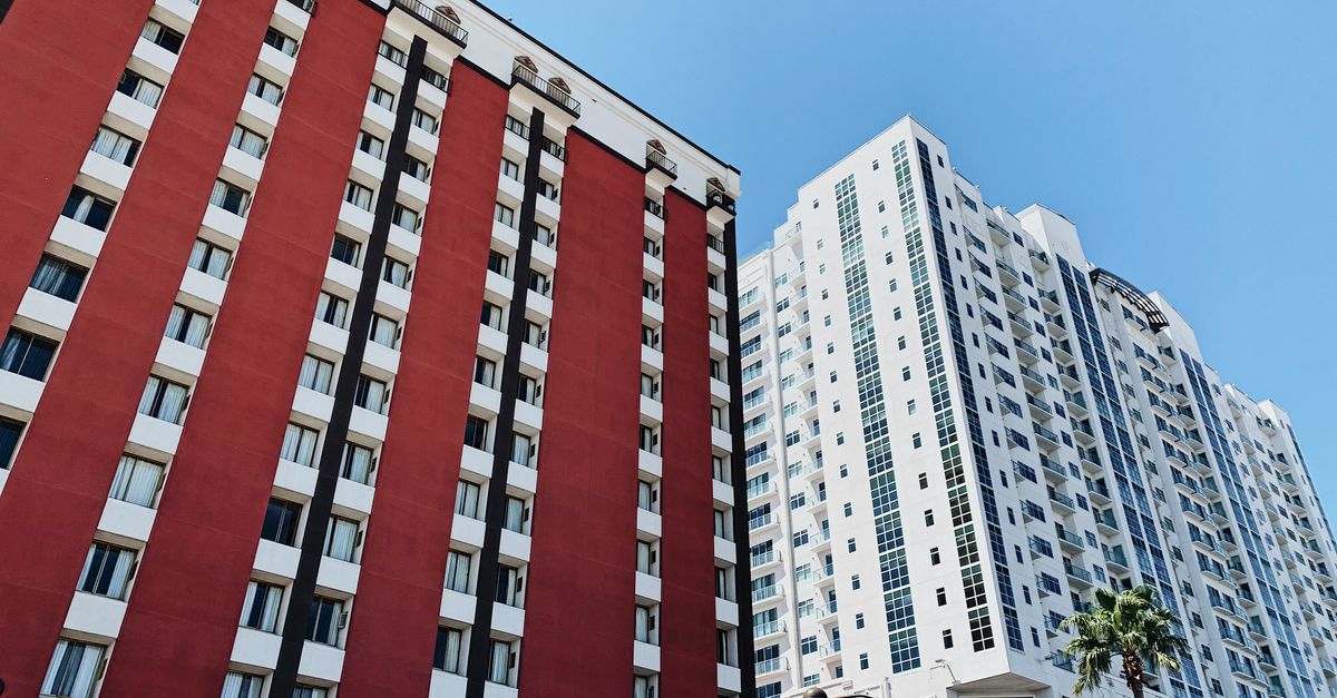Low-angle view of modern high-rise buildings in Las Vegas under a clear blue sky.
