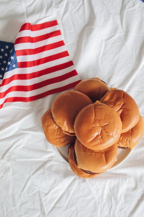 Flag Beside Burgers on a Plate