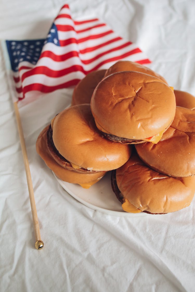 Flag Beside A Plate Of Burgers