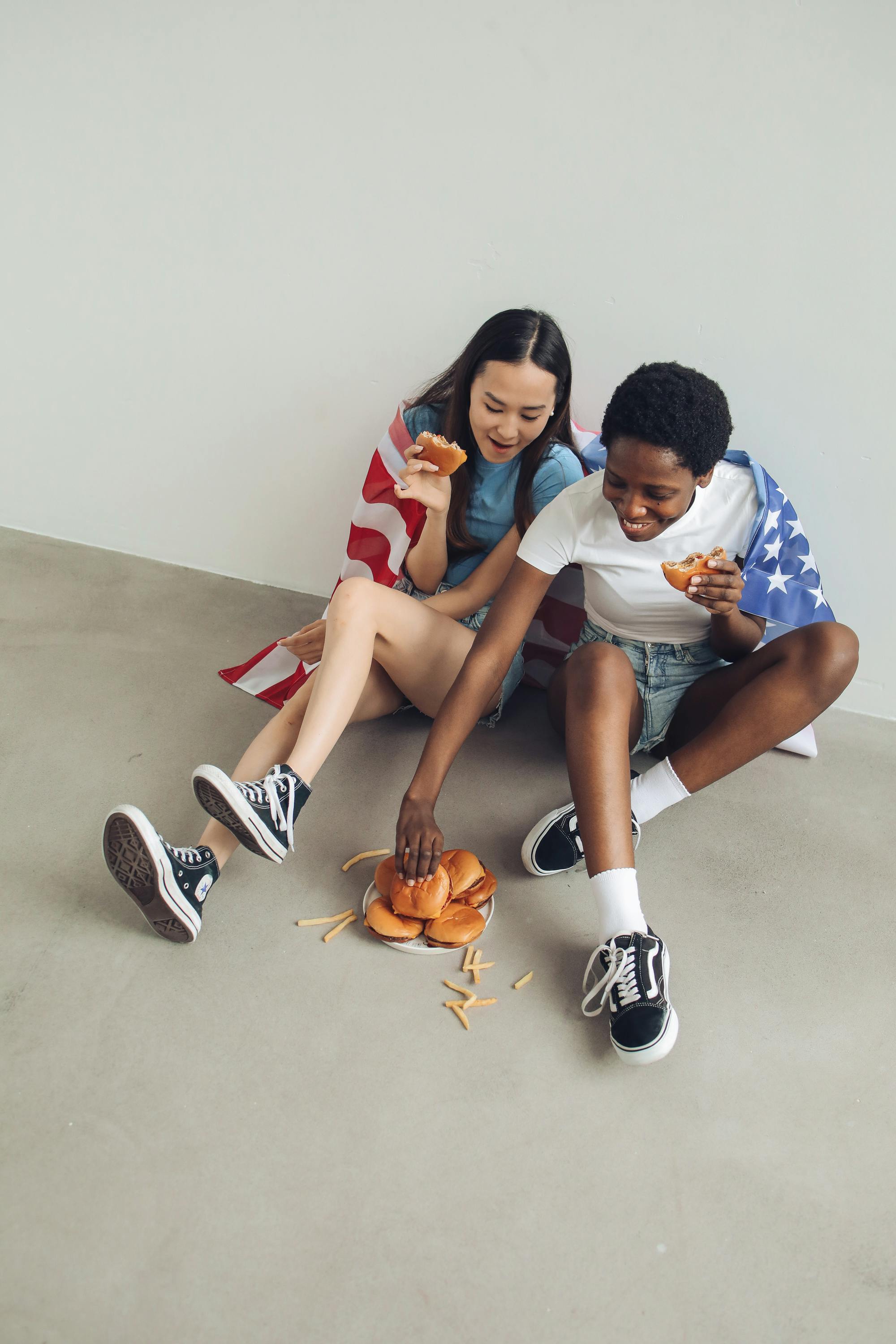 women sitting on the floor while eating