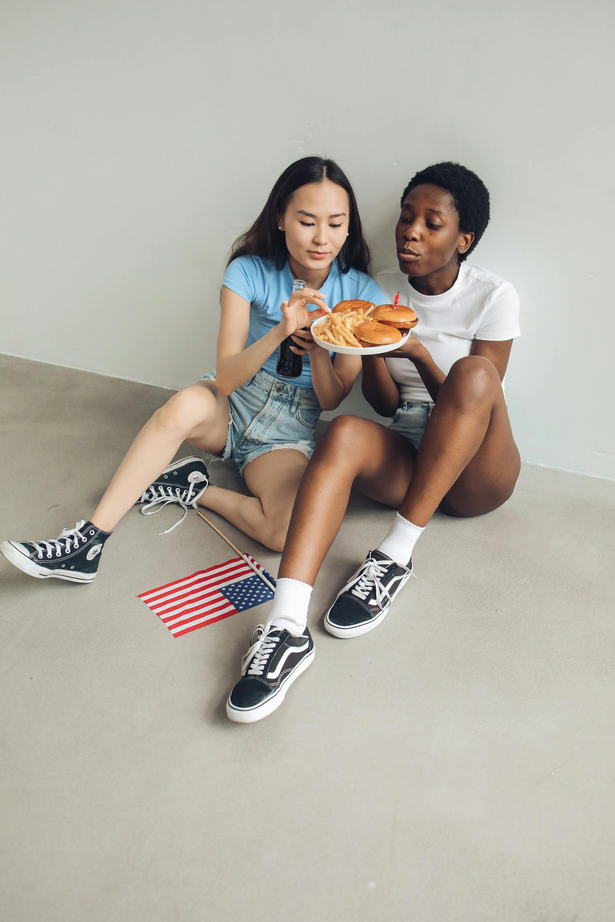 woman in denim shorts getting fries