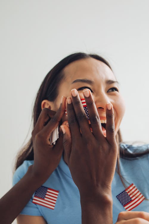 Woman in Blue Shirt with Sticker on the Face