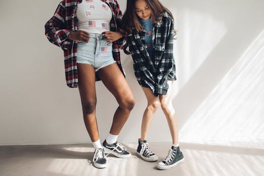 Two young women in trendy outfits striking a casual pose with American flag accents.