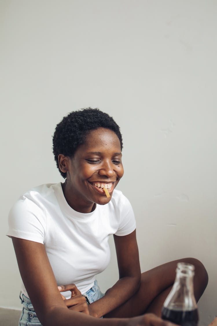 Woman In White Shirt Eating Fries