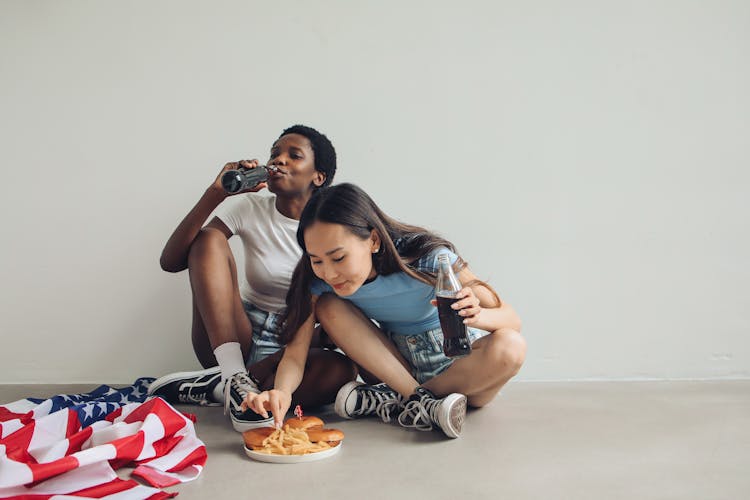 Women Eating Burgers And Fries