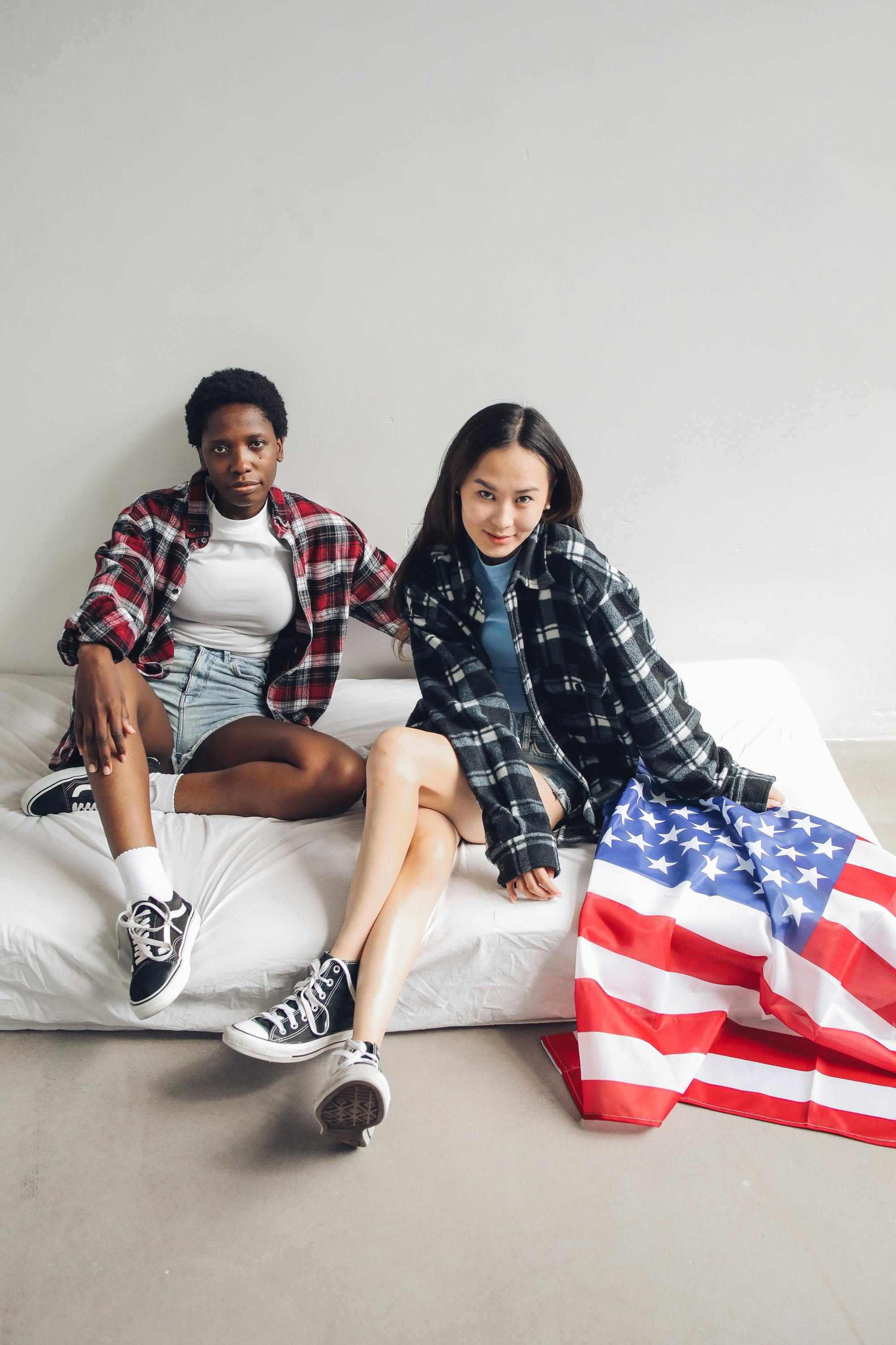 women sitting on a mattress