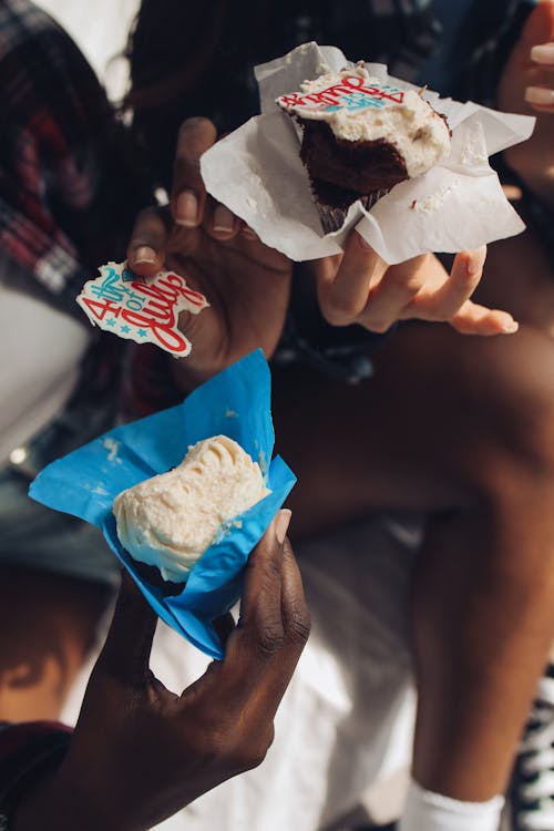 People Holding Cupcakes