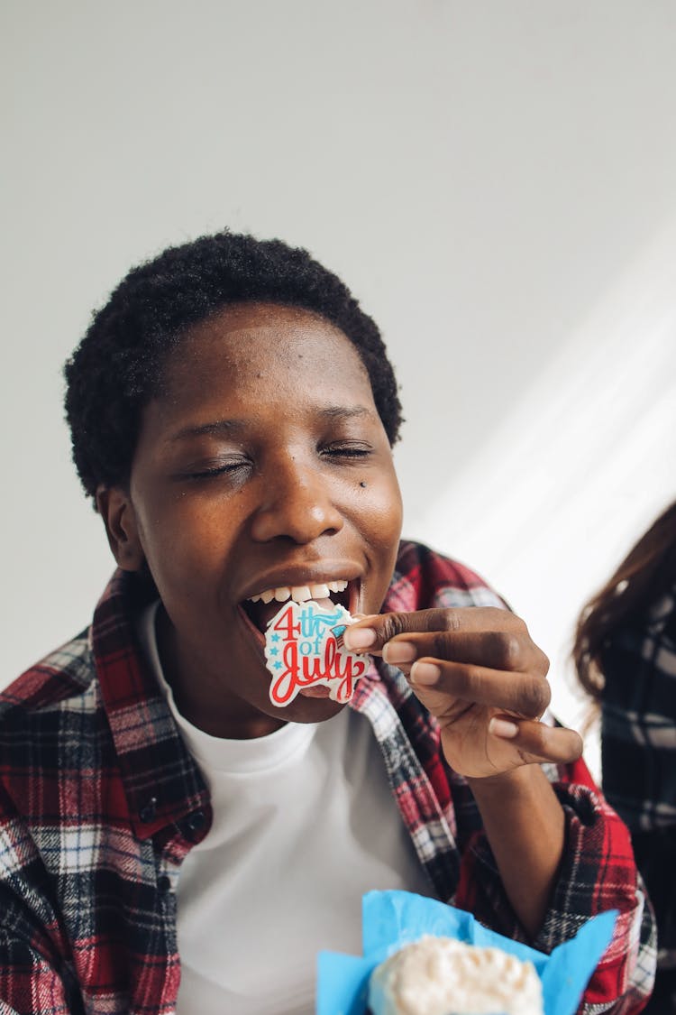 Woman Eating A Cupcake Topping