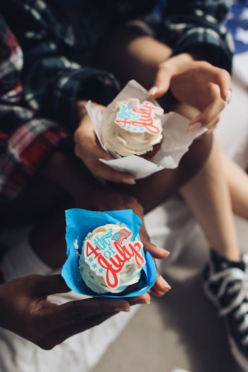 People Holding Cupcakes