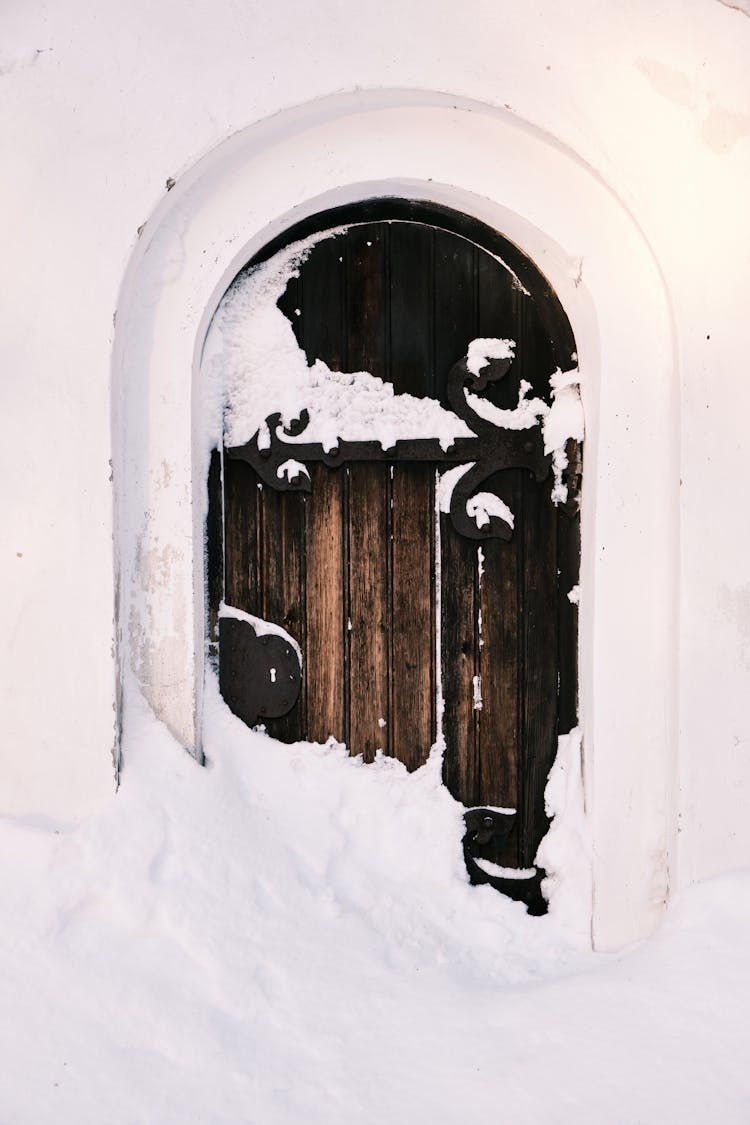 Brown Wooden Arch Door With Snow