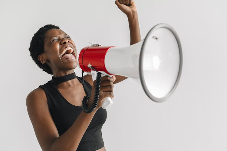 A Woman Shouting On A Megaphone